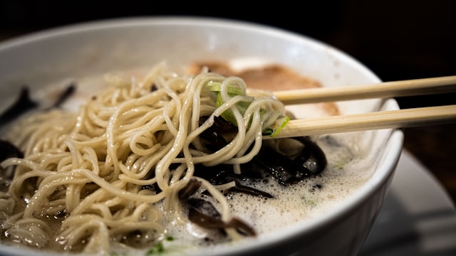 A steaming bowl of ramen being slurped at a Tokyo noodle shop